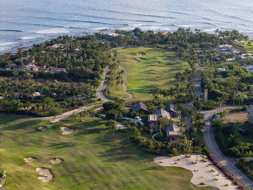 Sunset view of the expansive entertaining terraces and manicured gardens at La Punta Estates.